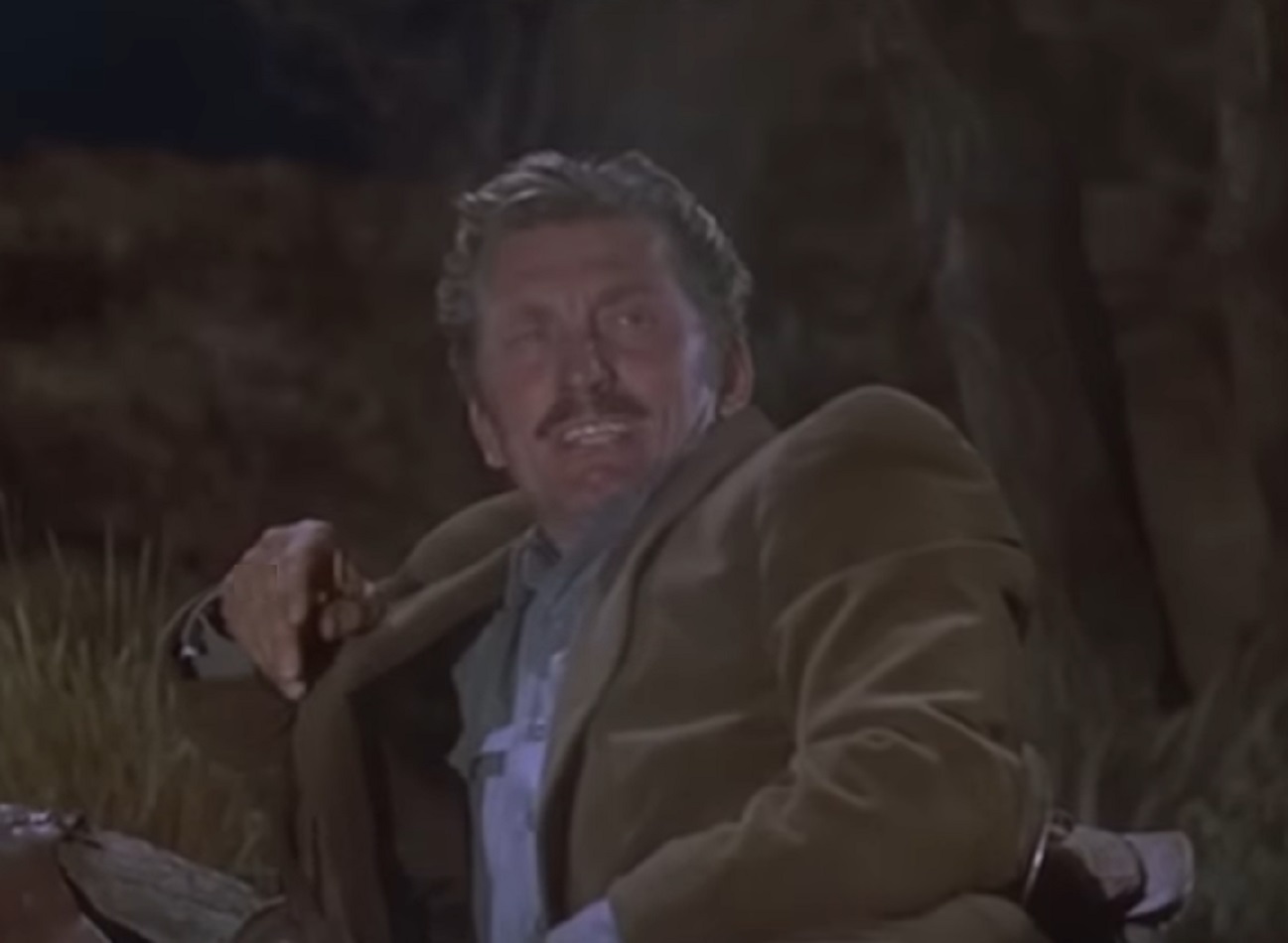 Screenshot of Kirk Douglas laying on the floor - from Gunfight at the O.K. Corral (1957)