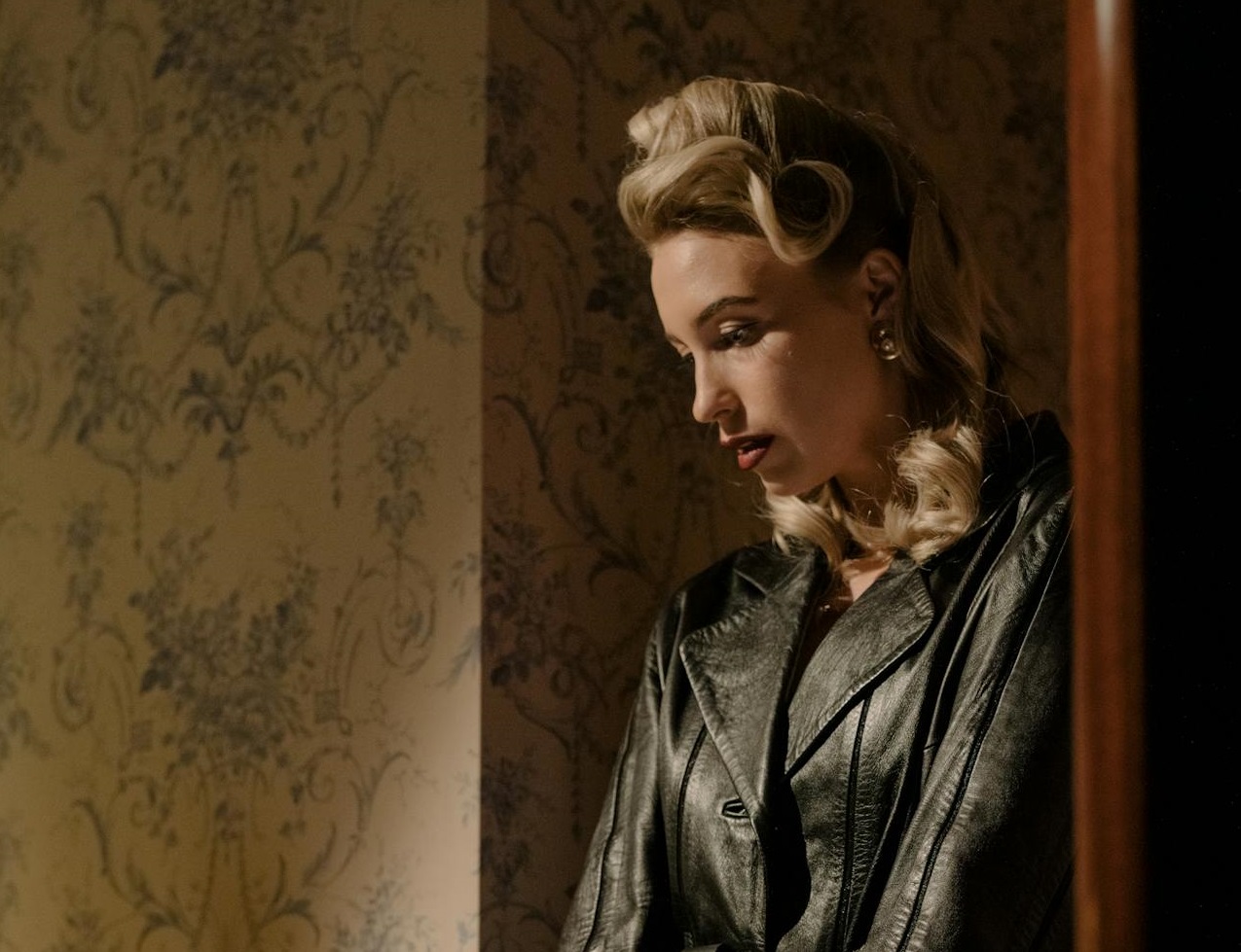 Woman in Black Leather Coat Standing By The Stairs
