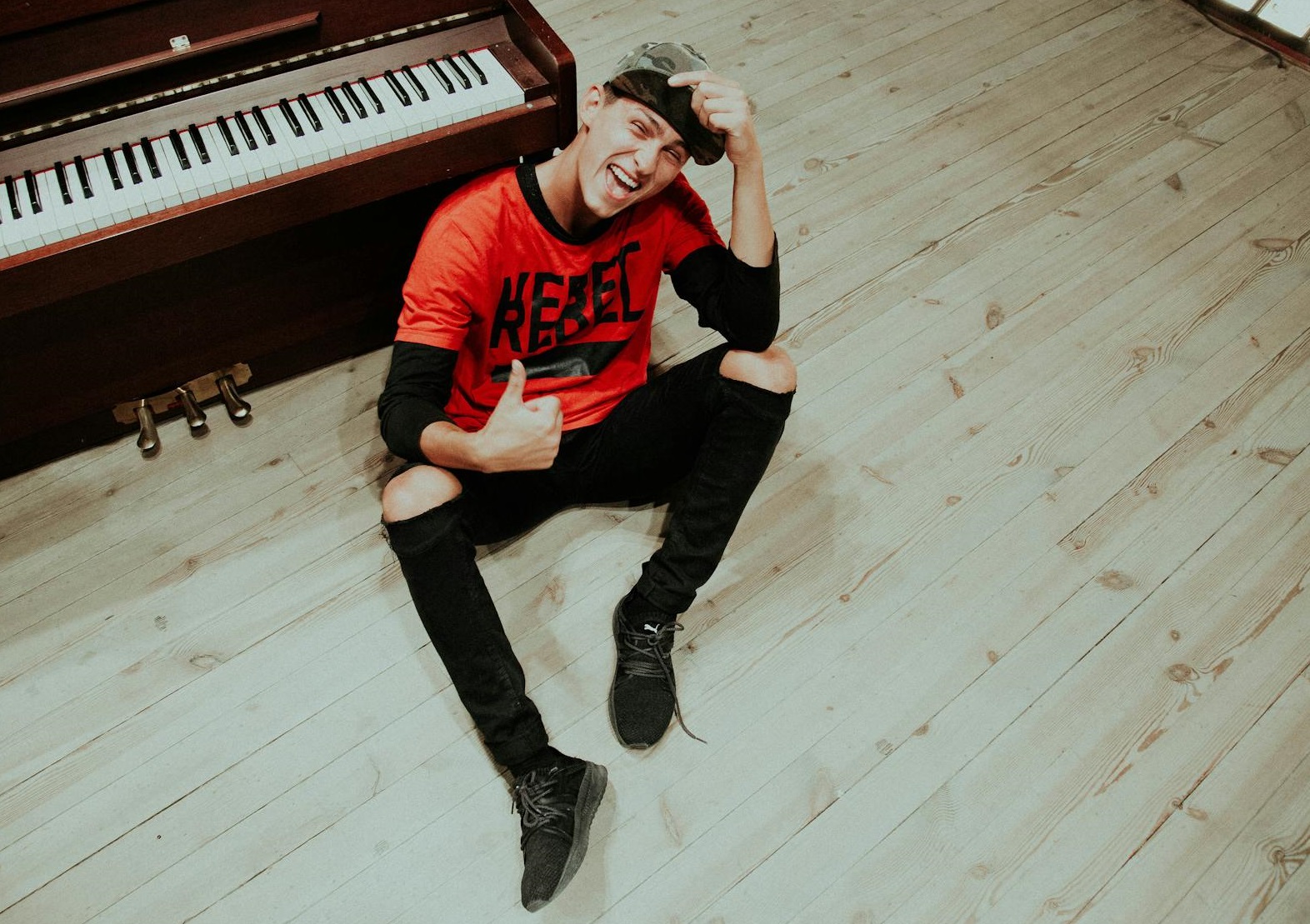 Young Man Sitting and Showing Thumbs Up