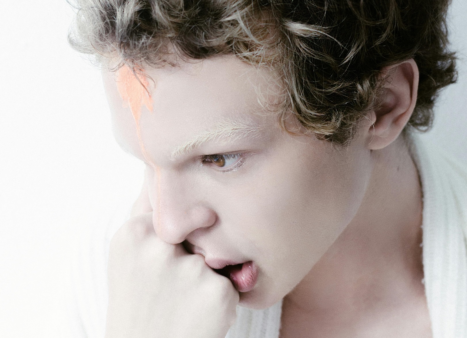Man with Curly Hair thinking and looking down.