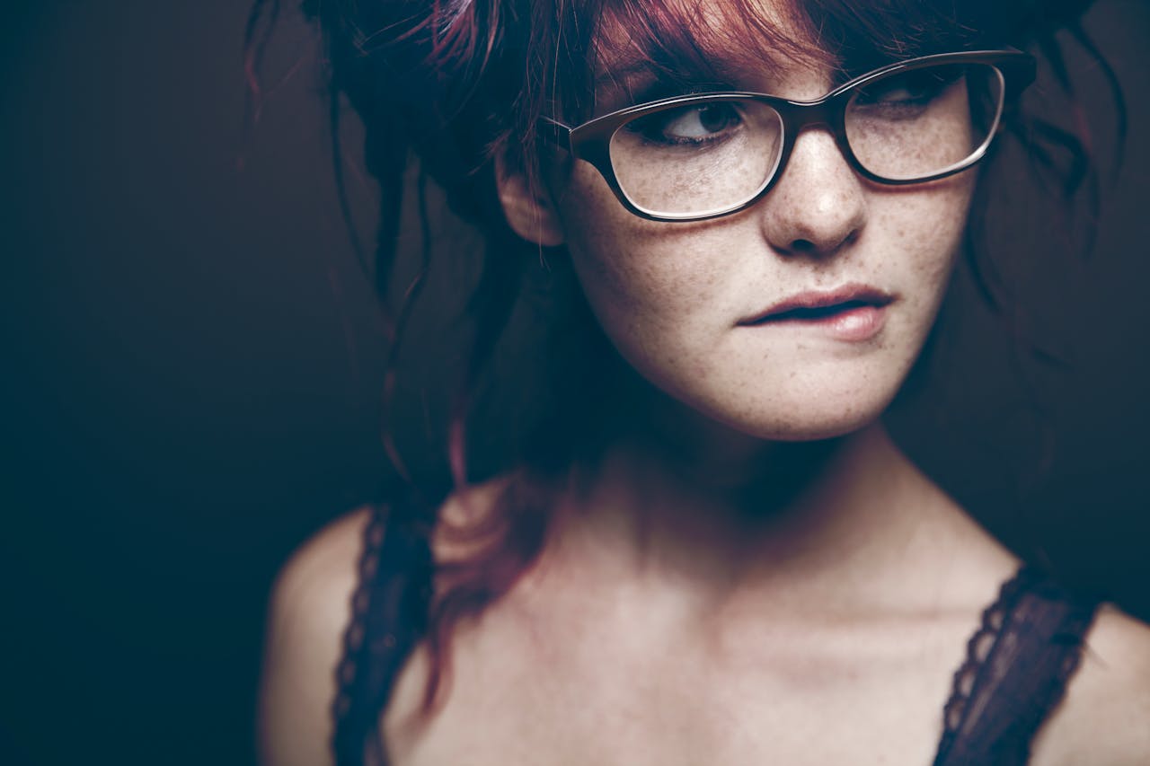 Close-up of a Woman with Freckles Biting her Lip