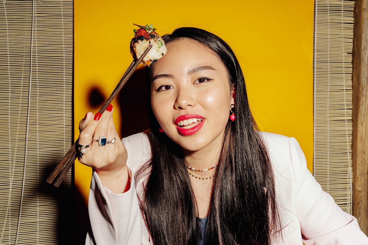 A Woman Picking Sushi with Chopsticks