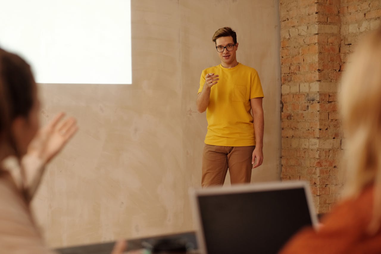 Man Wearing a Yellow Shirt Doing a Presentation