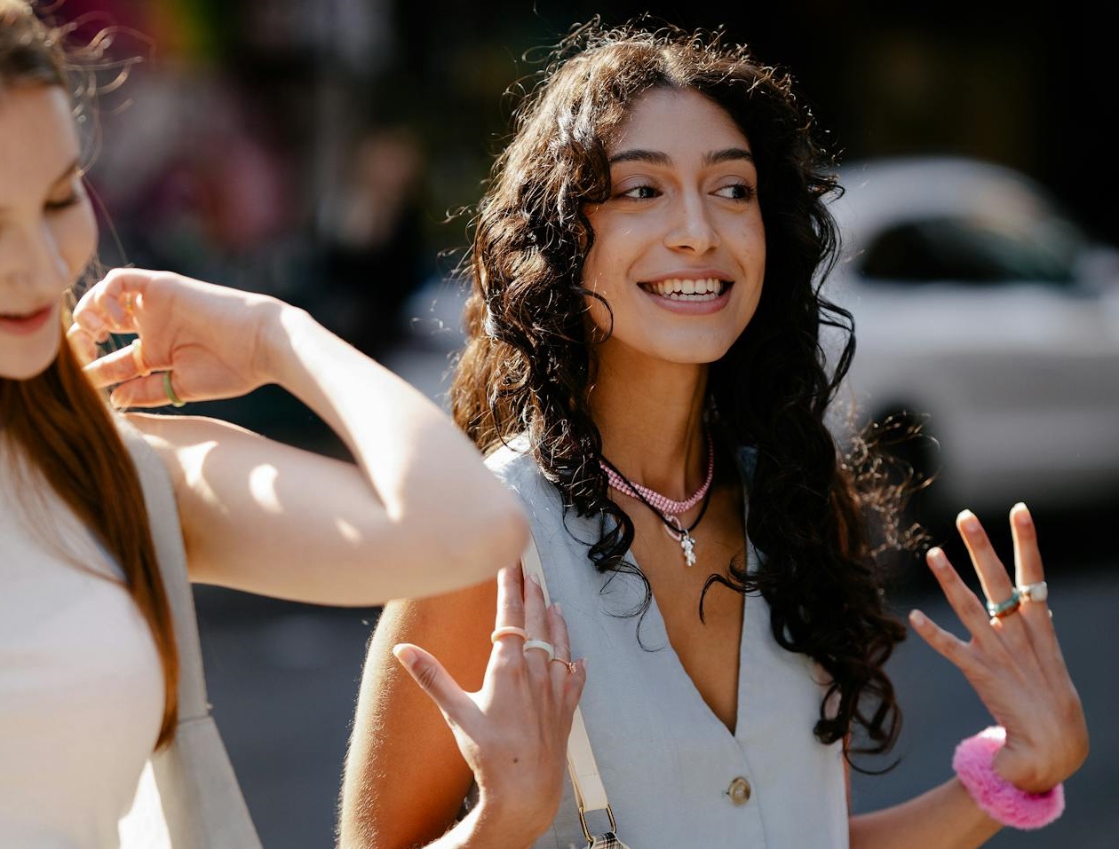 Two girls talking outside.