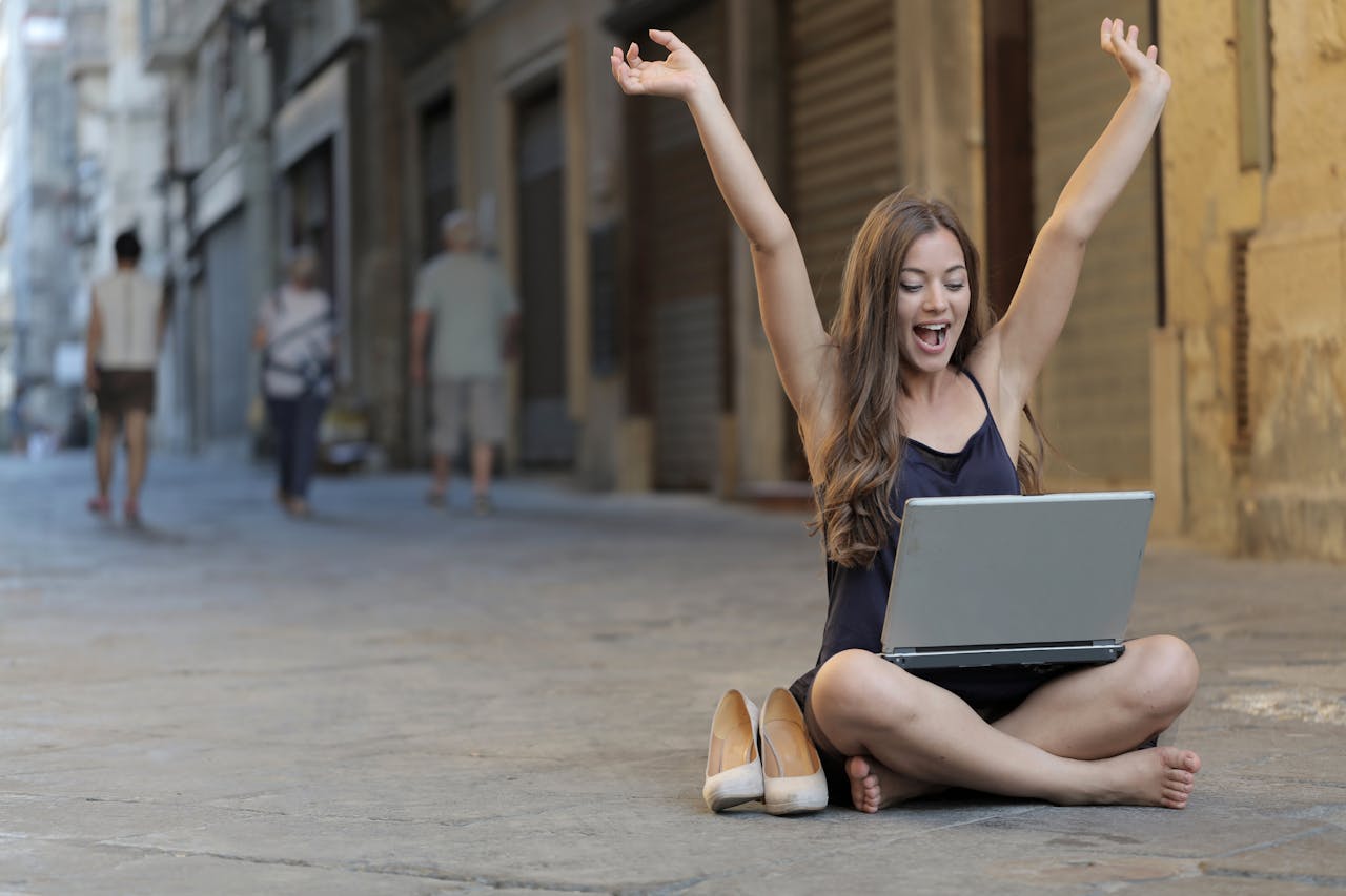 Woman Raising Her Hands Up While Sitting on Floor