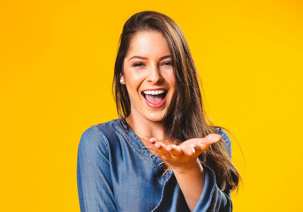 Woman Wearing Blue Top is smiling and looking at camera.