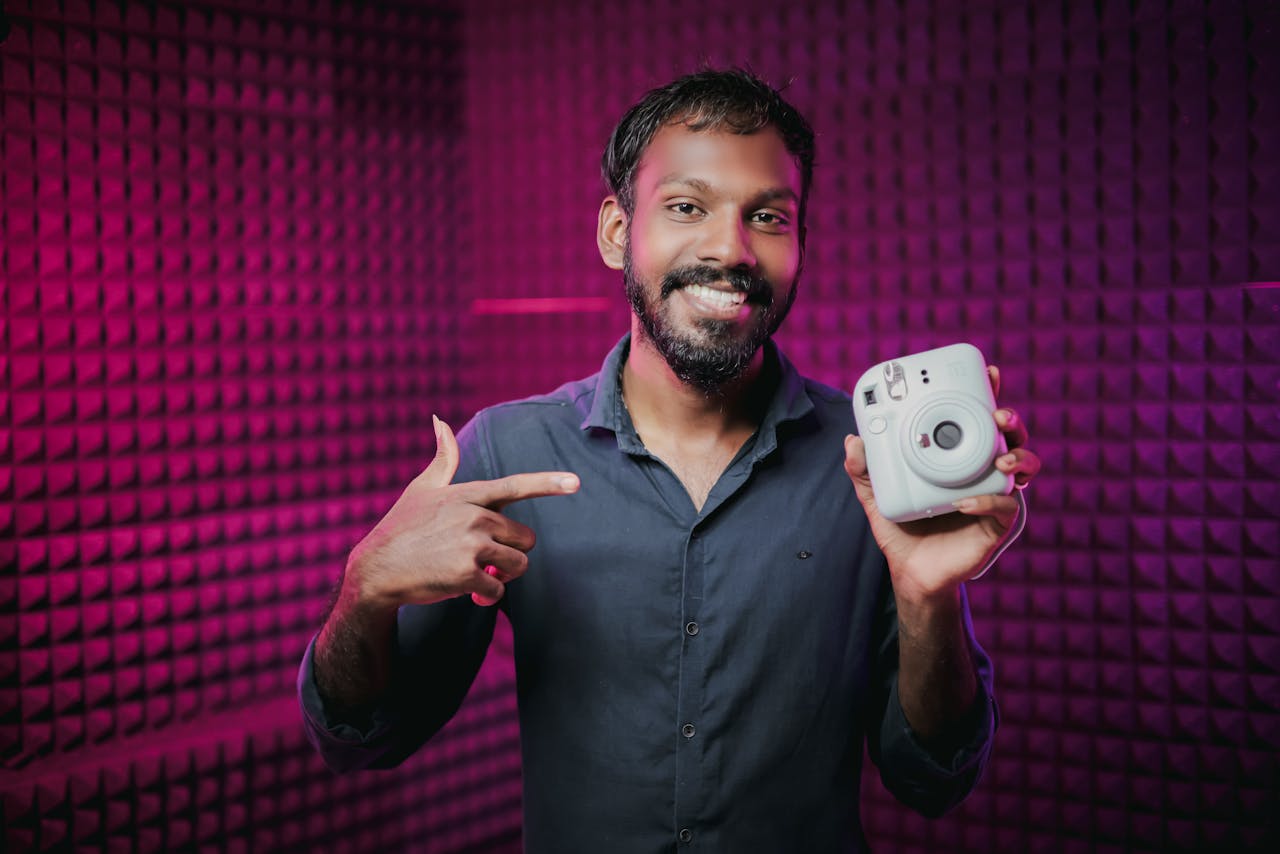 Happy man Holding an Instant Camera
