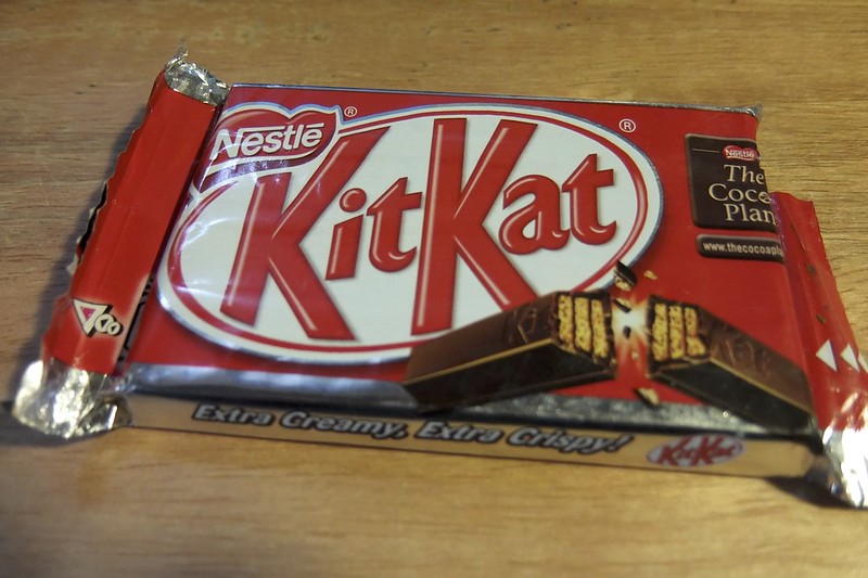 Close-up Photo of Kit Kat bar placed on a wooden table