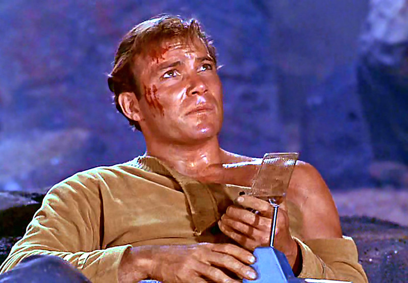Portrait Photo of William Shatner as Capt. Kirk holding a communication device