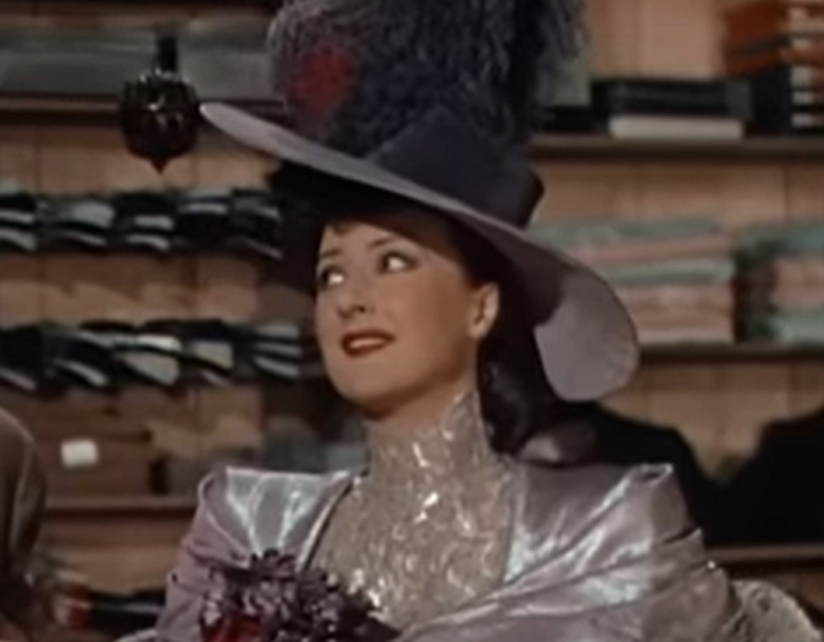 Screenshot of Gypsy Rose Lee looking at side and smiling -  from Belle of the Yukon (1944)