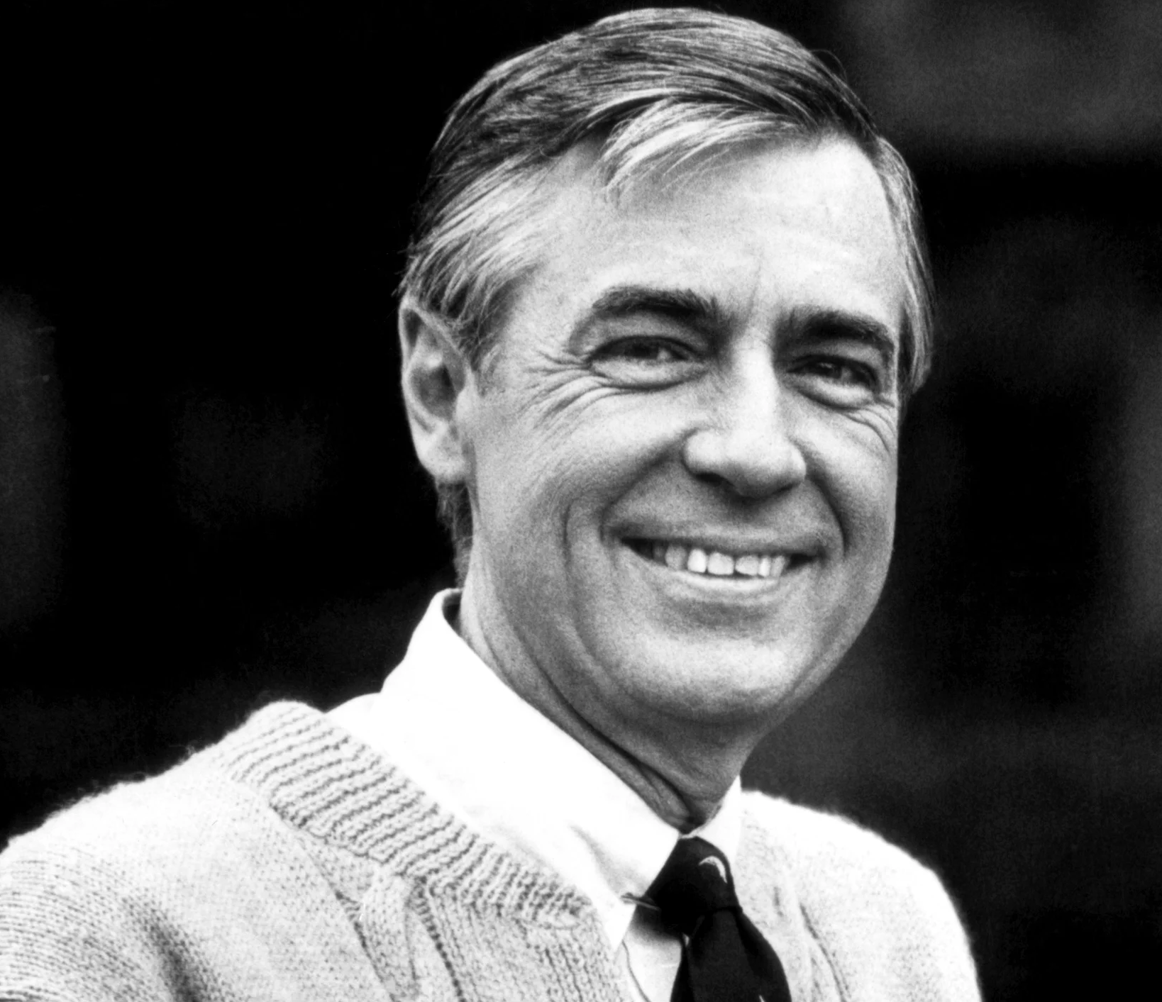 Grayscale photo of Fred Rogers in light colored sweater