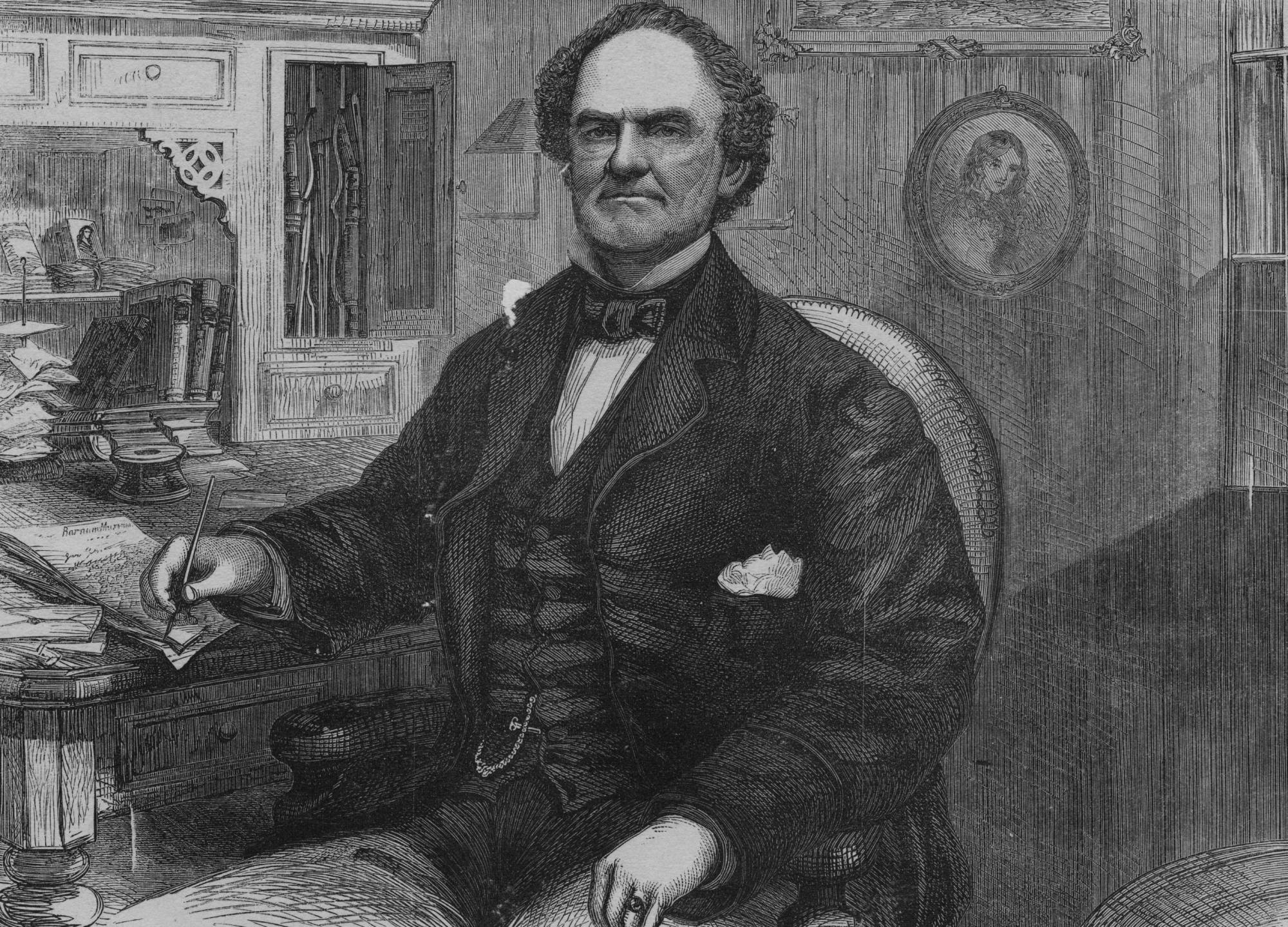 Barnum in suit sitting at a table