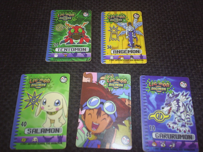 Close Up Photo of Digimon Cards on a dark surface