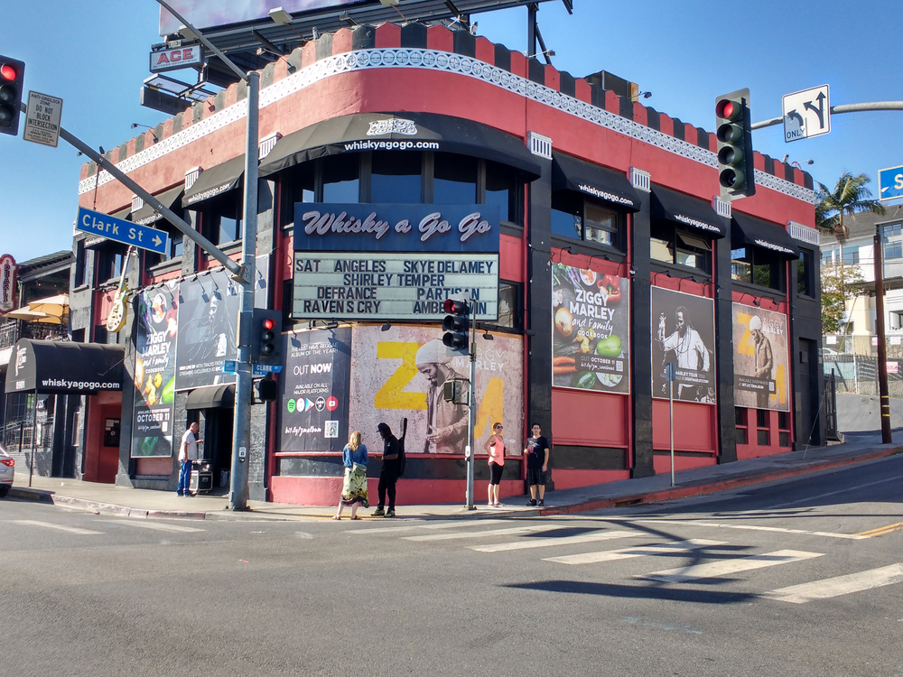 A musician stands in front of the Whisky a Go Go club