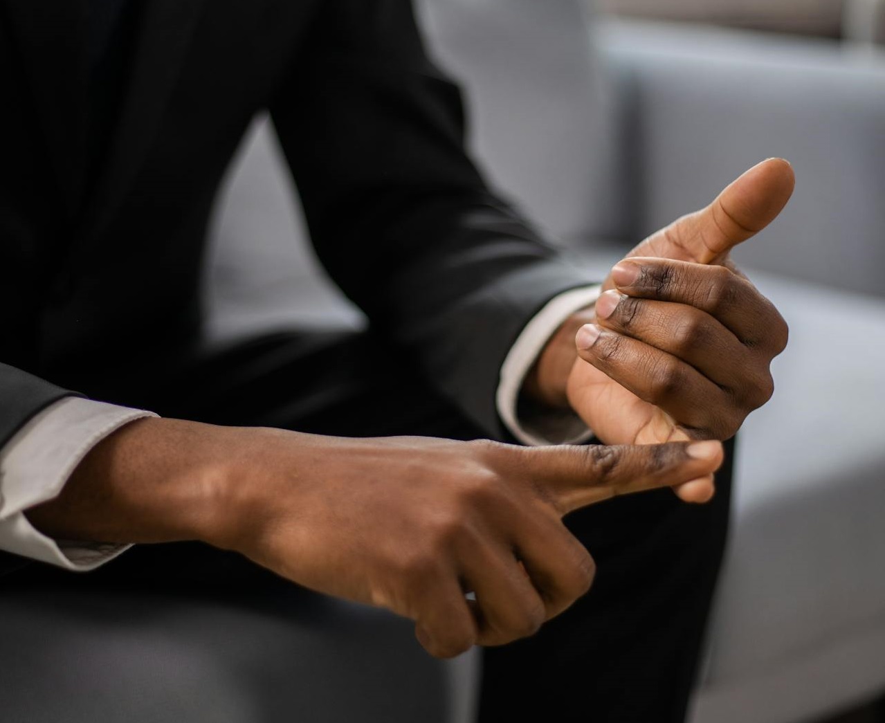 A Close-Up Shot of a Man Counting on His Fingers