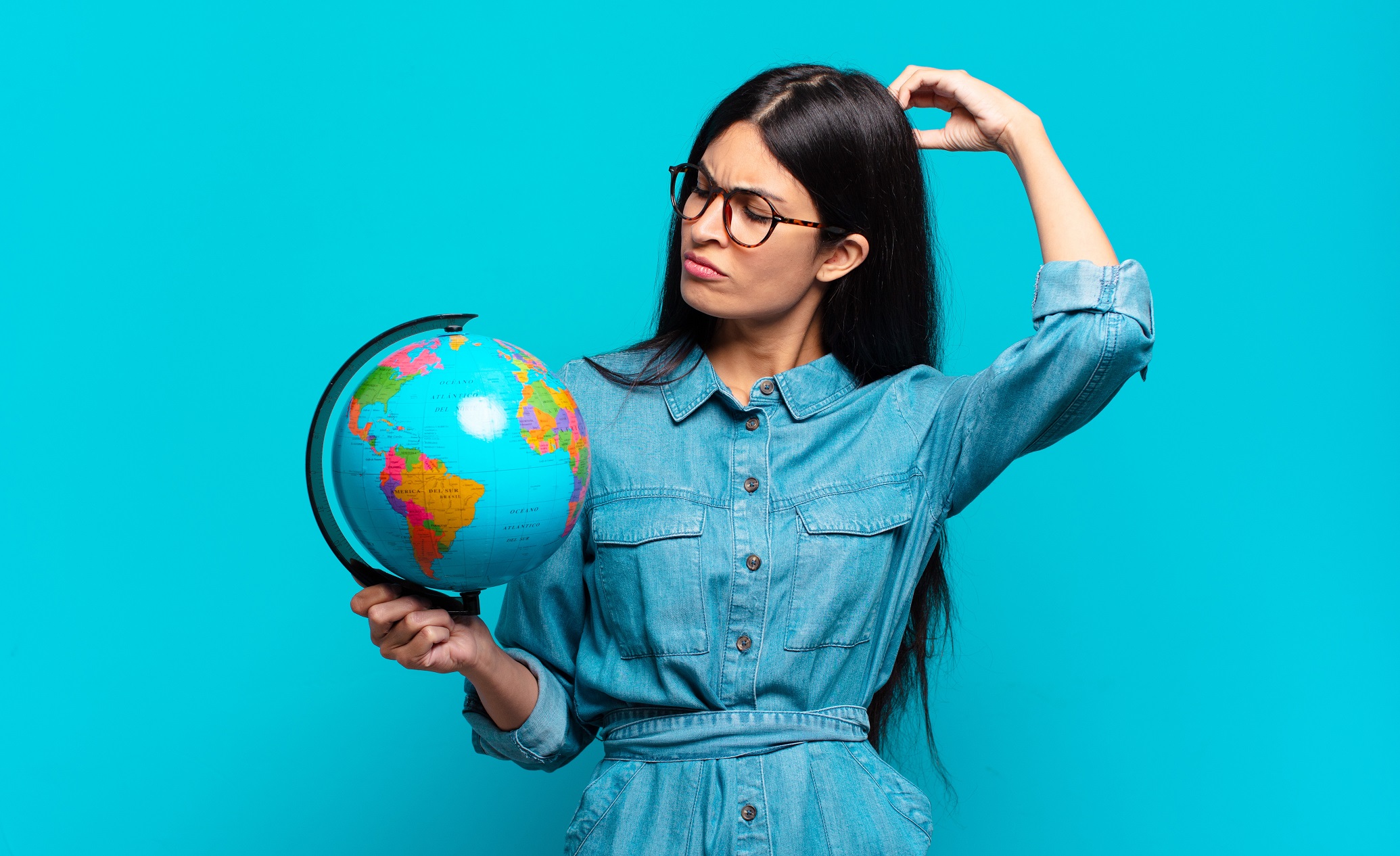 Young woman feeling puzzled and confused looking to the earth.