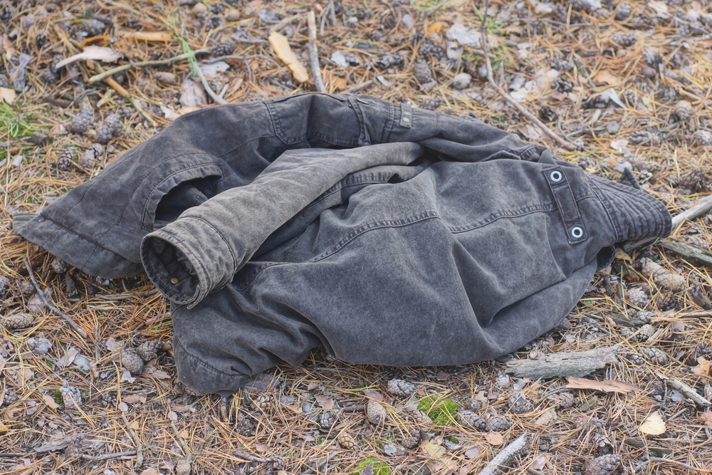 one gray winter fabric jacket lies on the ground