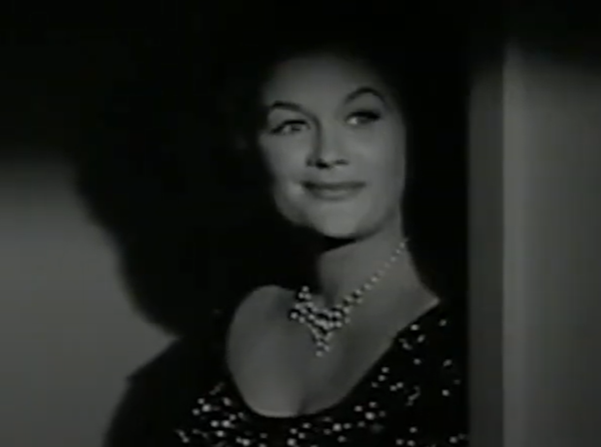 Screenshot of Jean Hagen looking at front and smiling - from Spring Reunion (1956)