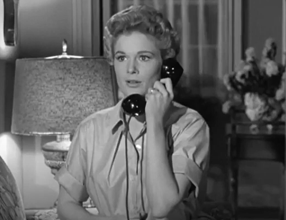 Screenshot of Jean Hagen talking on the telephone - from Half a Hero (1953)