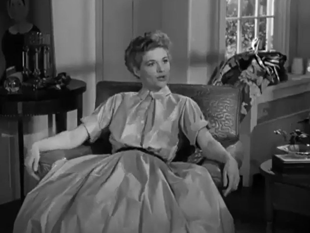 Screenshot of Jean Hagen seating and looking at side - from Half A Hero (1953)