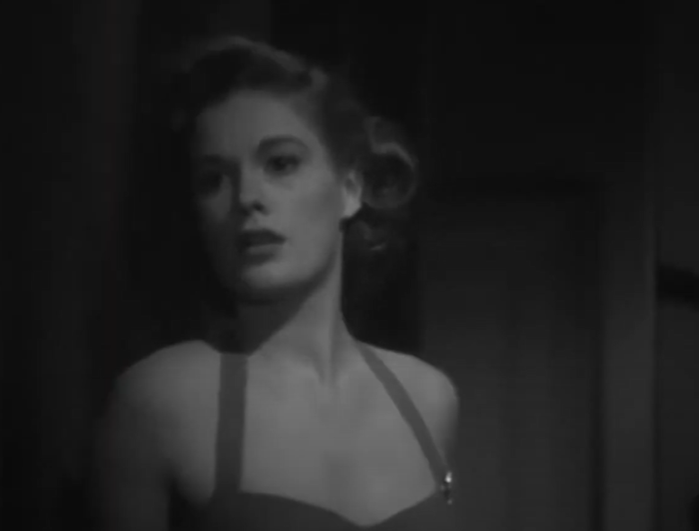 Screenshot of Jean Hagen seating and looking upset - from Side Street (1949)