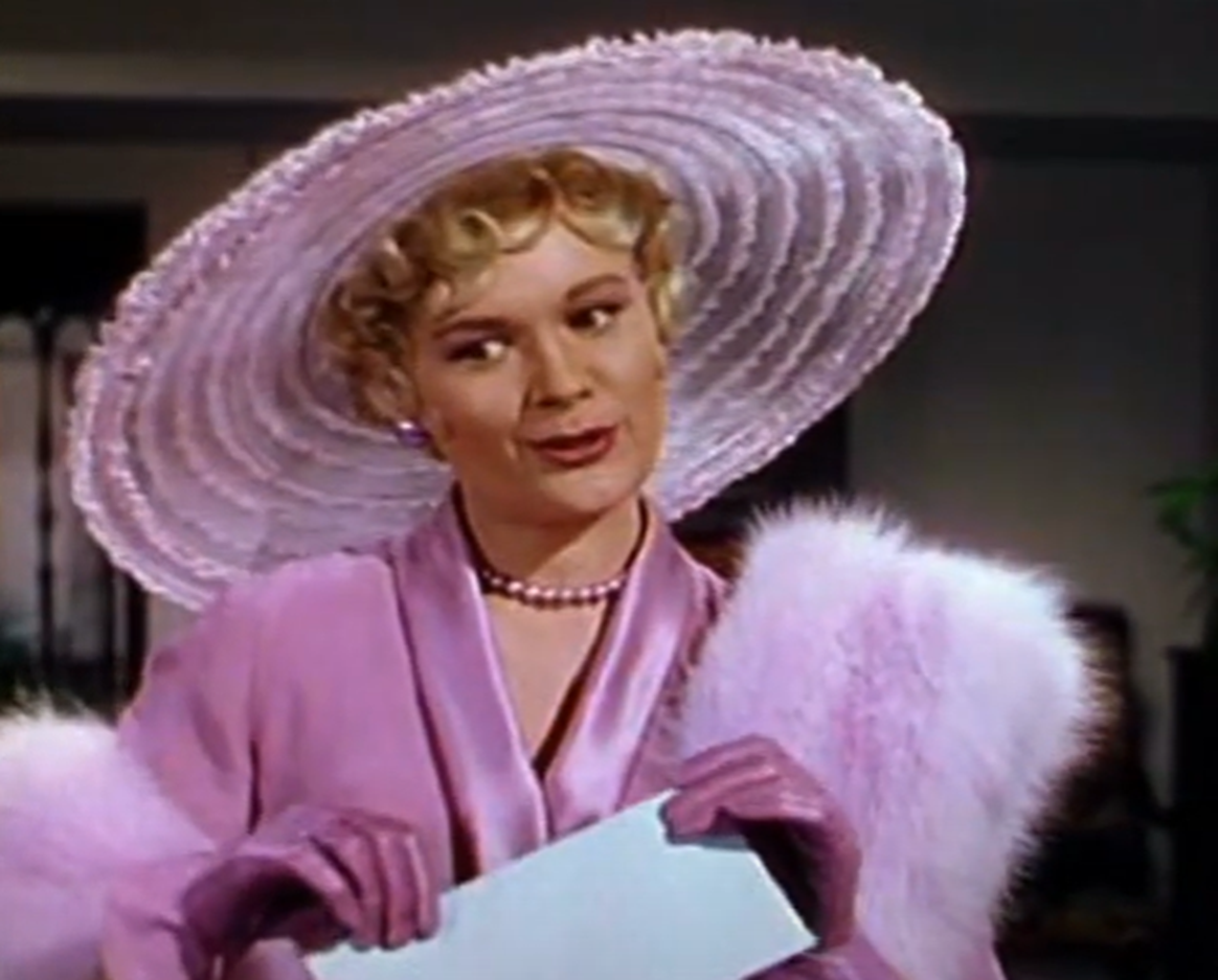 Screenshot of Jean Hagen on pink clothes looking at side - from Singin' In The Rain (1952)