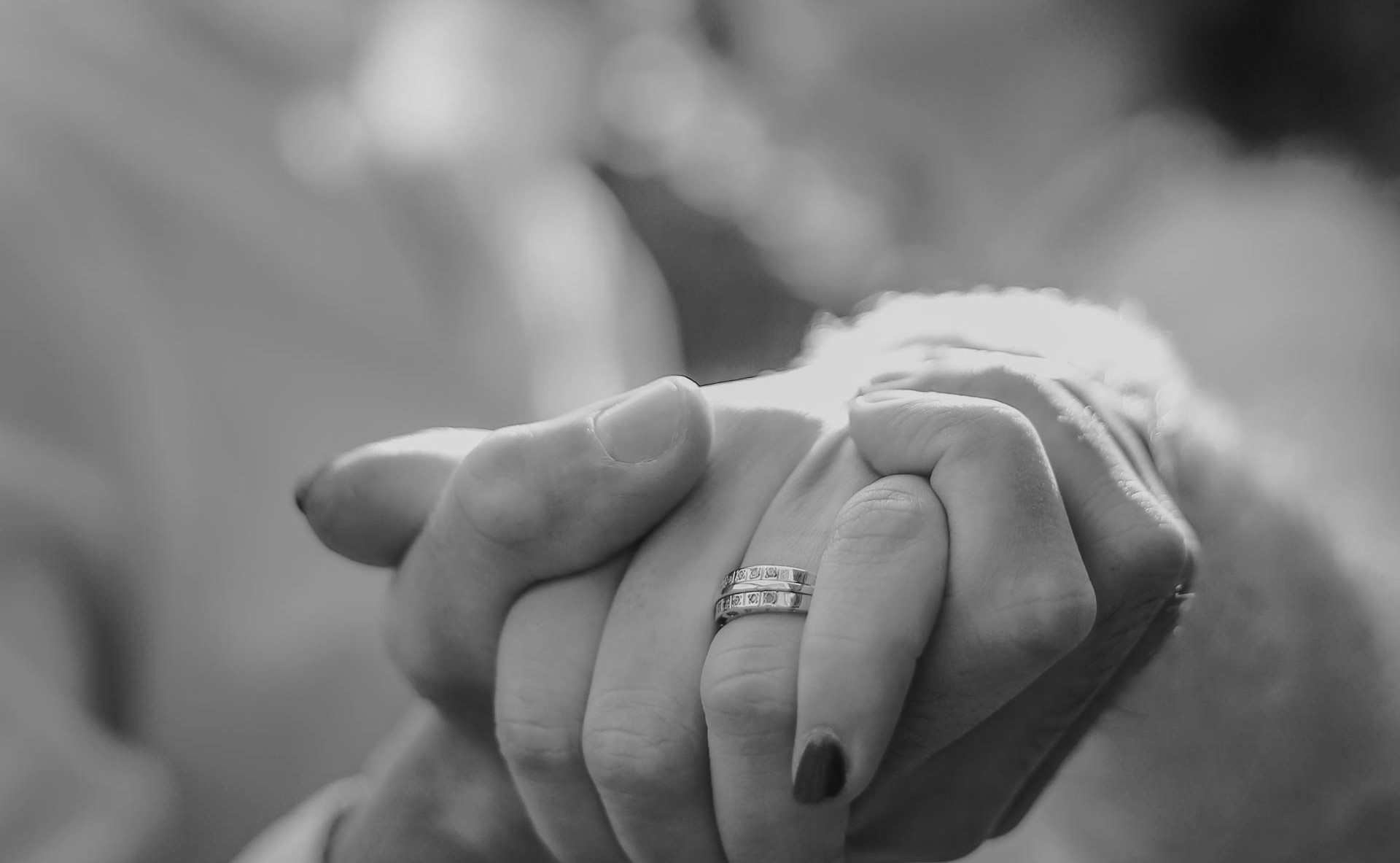 Crop bride and groom holding hands in dance