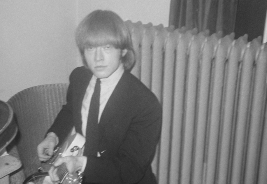 guitarist with English rock and roll group The Rolling Stones posed backstage