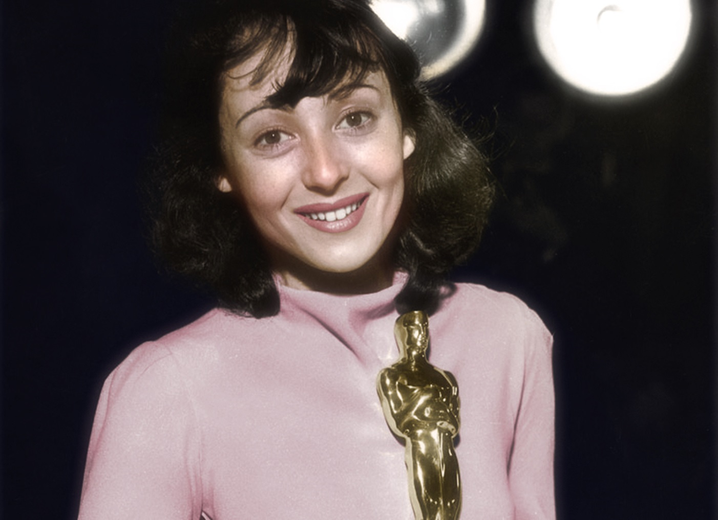 Luise Rainer smiling and looking at camera.