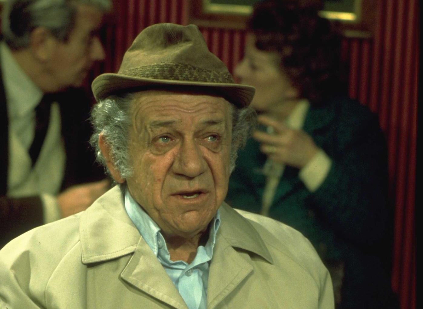 Actor Sid James in character as Sid Abbott.