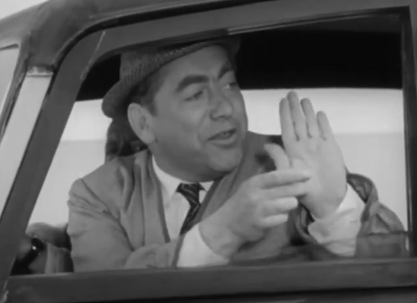 Screenshot of Tony Hancock seating in the car - from The Punch and Judy Man (1963)