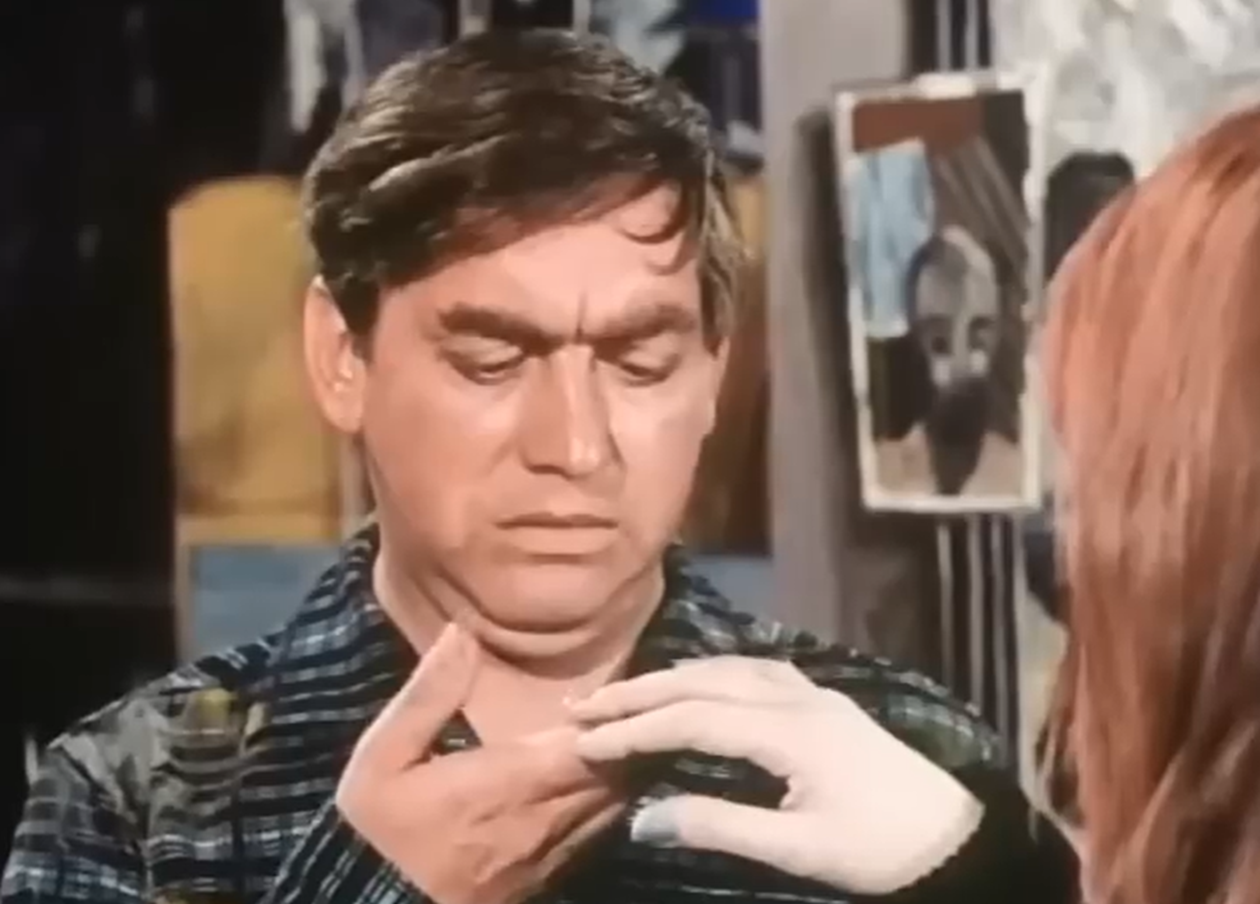 Screenshot of Tony Hancock looking at female hand  - from The Rebel (1961)