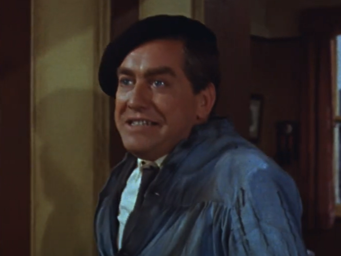 Screenshot of Tony Hancock looking at side and smiling - from The Rebel (1961)