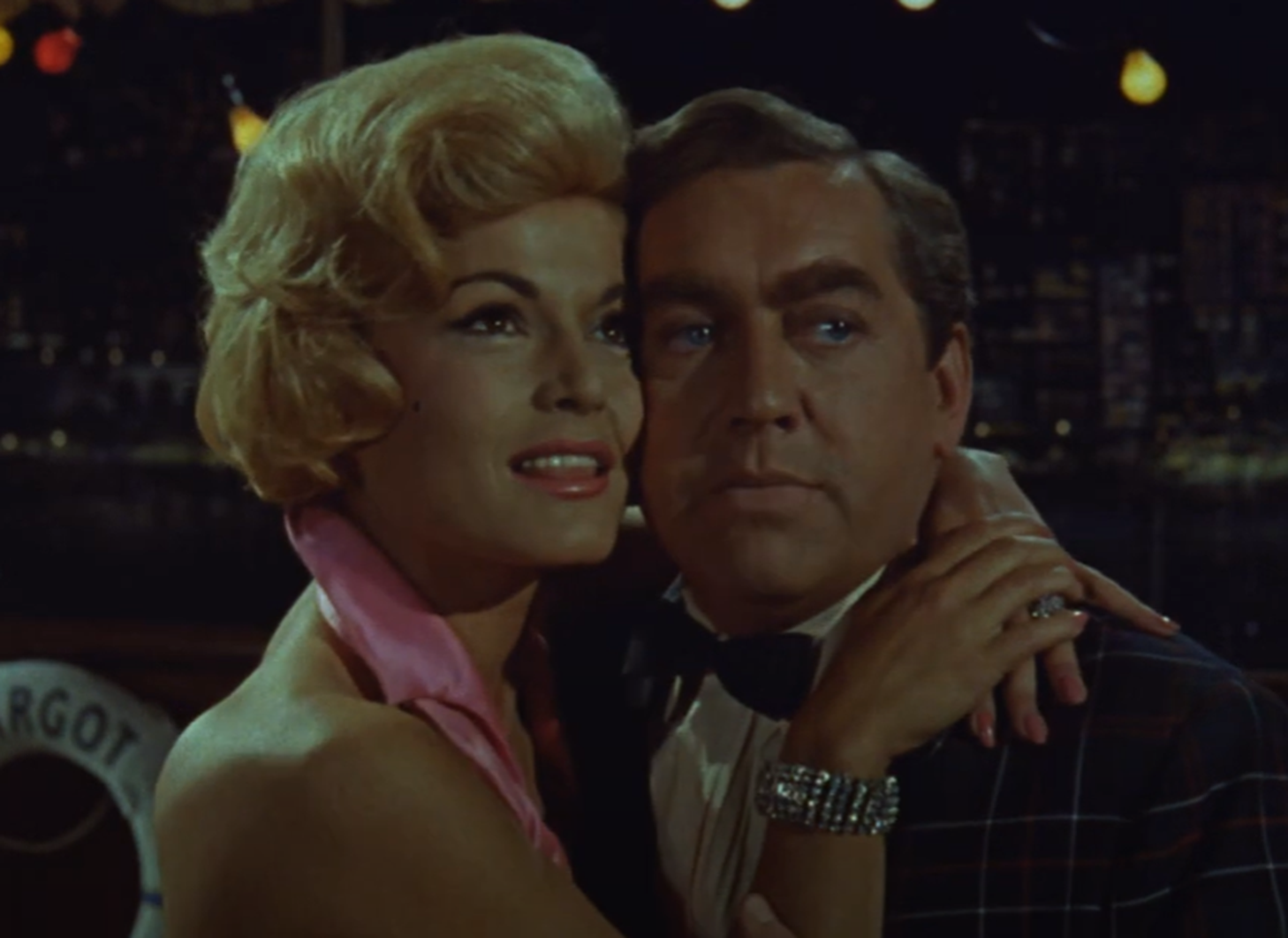 Screenshot of Tony Hancock and Margit Saad looking at camera  - from The Rebel (1961)