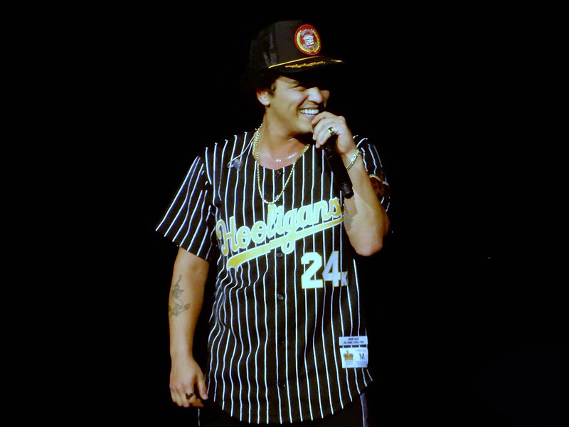 Portrait Photo of Bruno Mars in dark outfit and dark hat