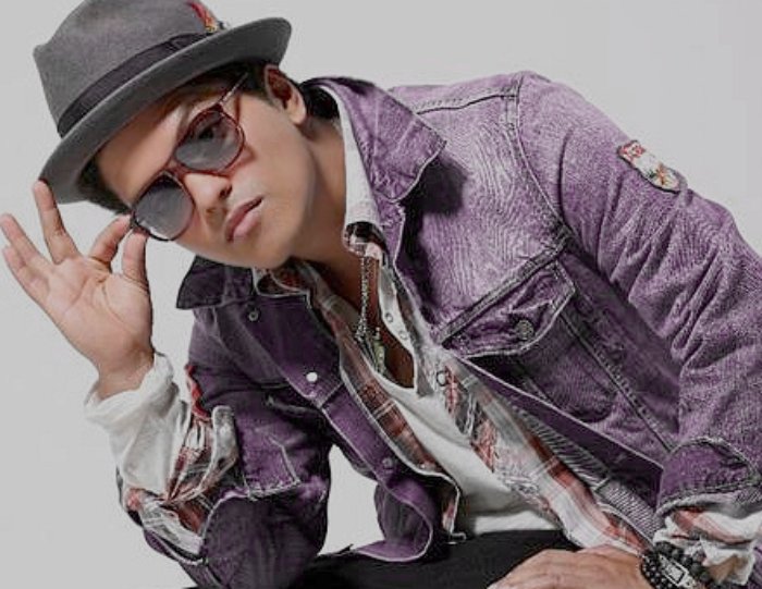 Portrait Photo of Bruno Mars in a denim jacket and a hat