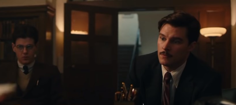 Jack Reynor as Jack Parsons in Strange Angel and Richard Onsted sitting in office in suits