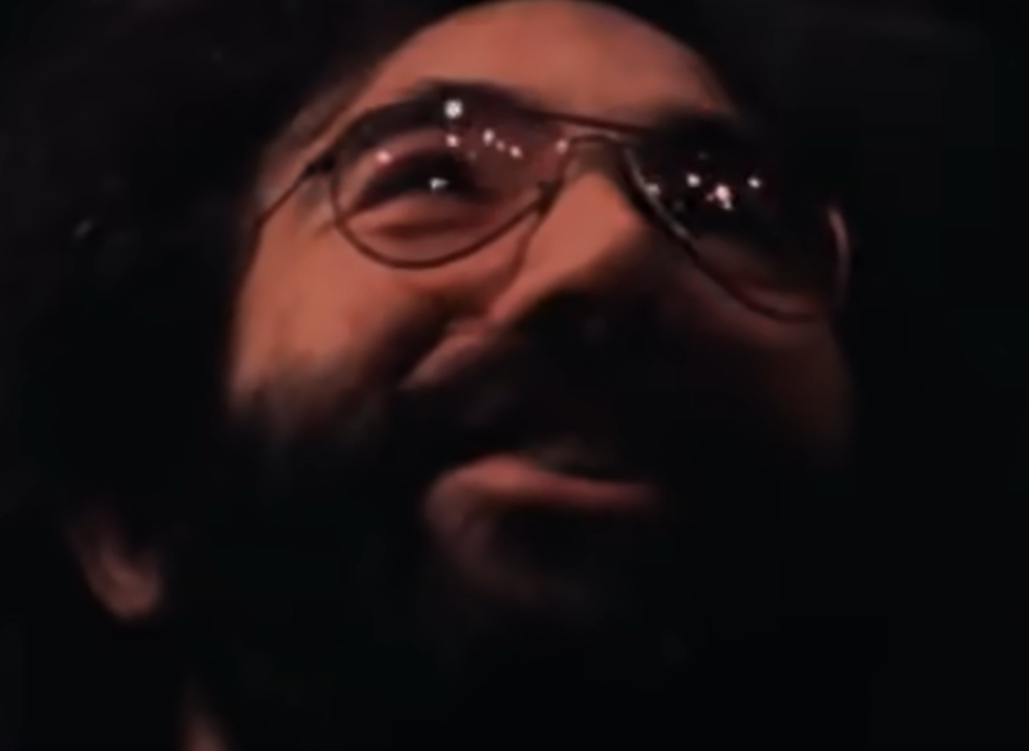 Screenshot of Jerry Garcia smiling on stage - from The Grateful Dead (1977)