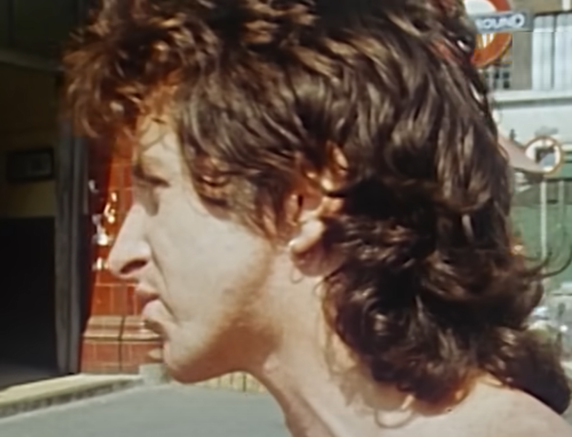 Screenshot of Bonn Scott looking at side from - On The Brink (2022)