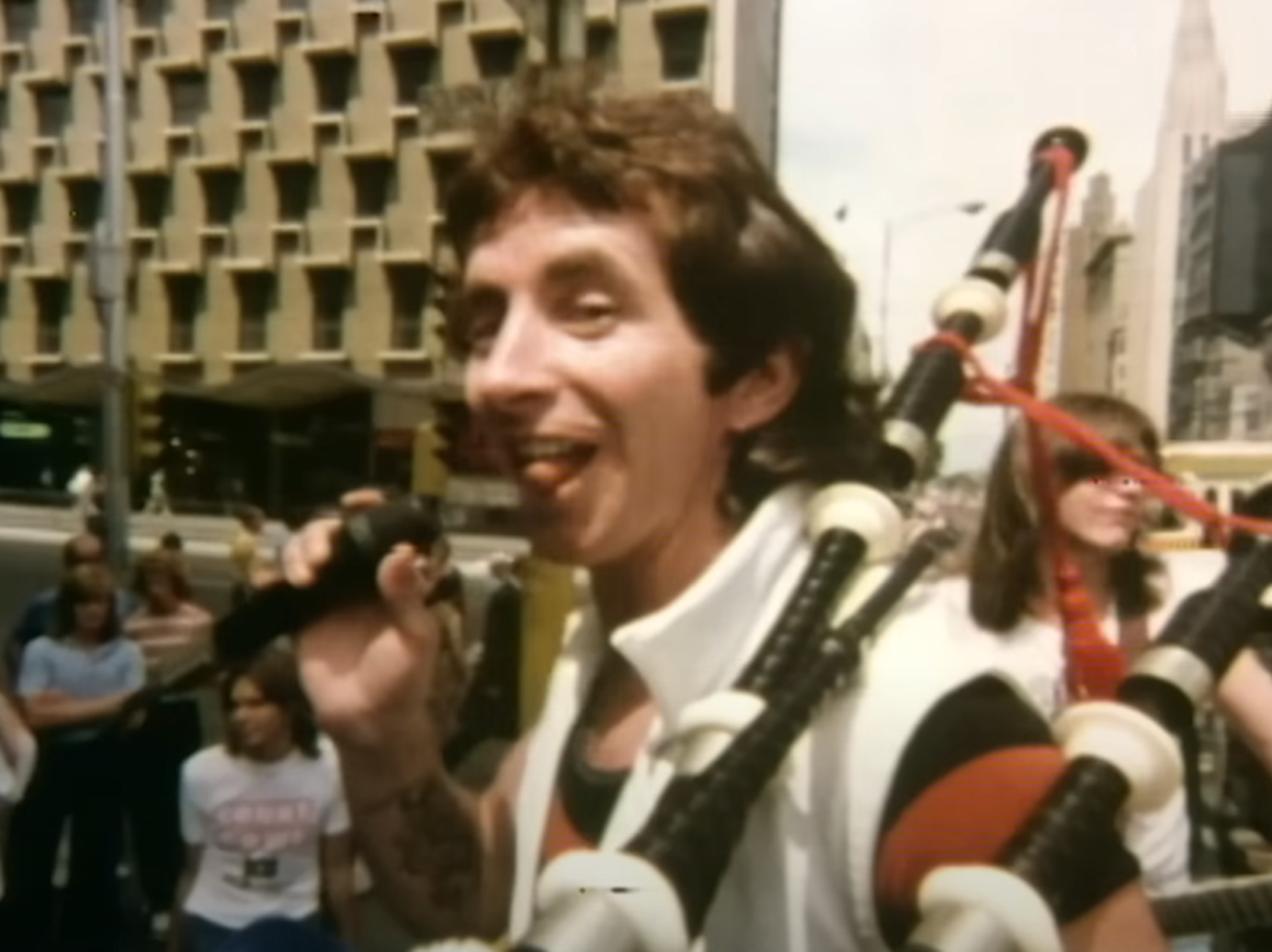 Screenshot of Bonn Scott playing on bagpipes from - On The Brink (2022)