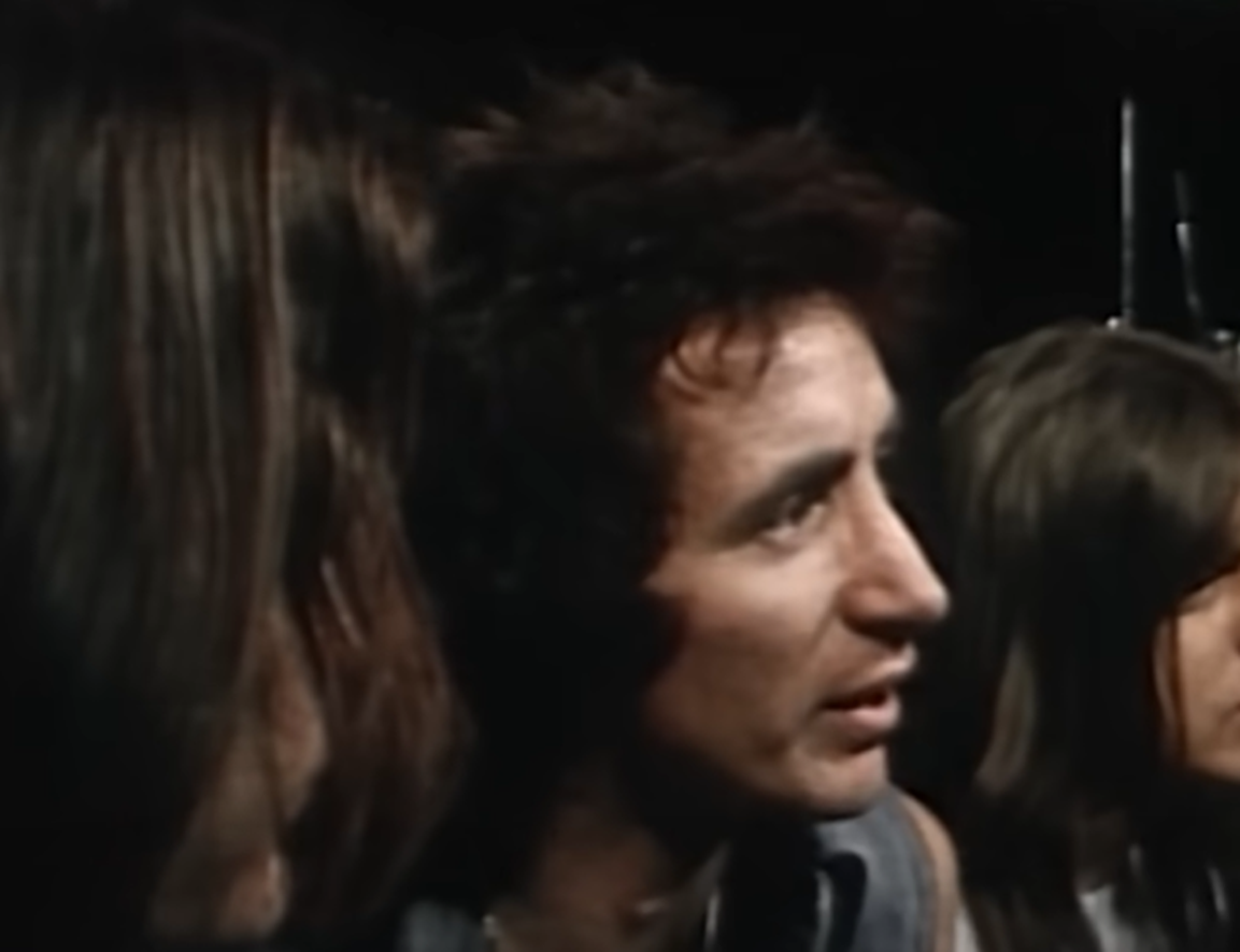 Screenshot of Bonn Scott looking at side from - On The Brink (2022)