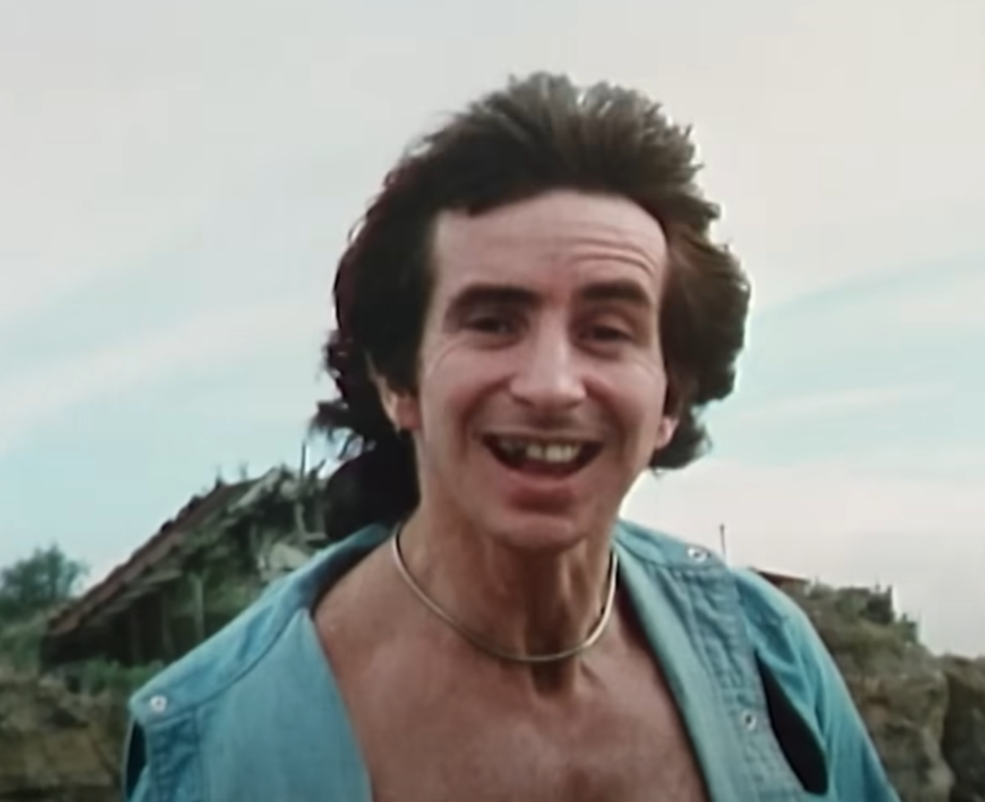Screenshot of Bonn Scott smiling at camera from - On The Brink (2022)