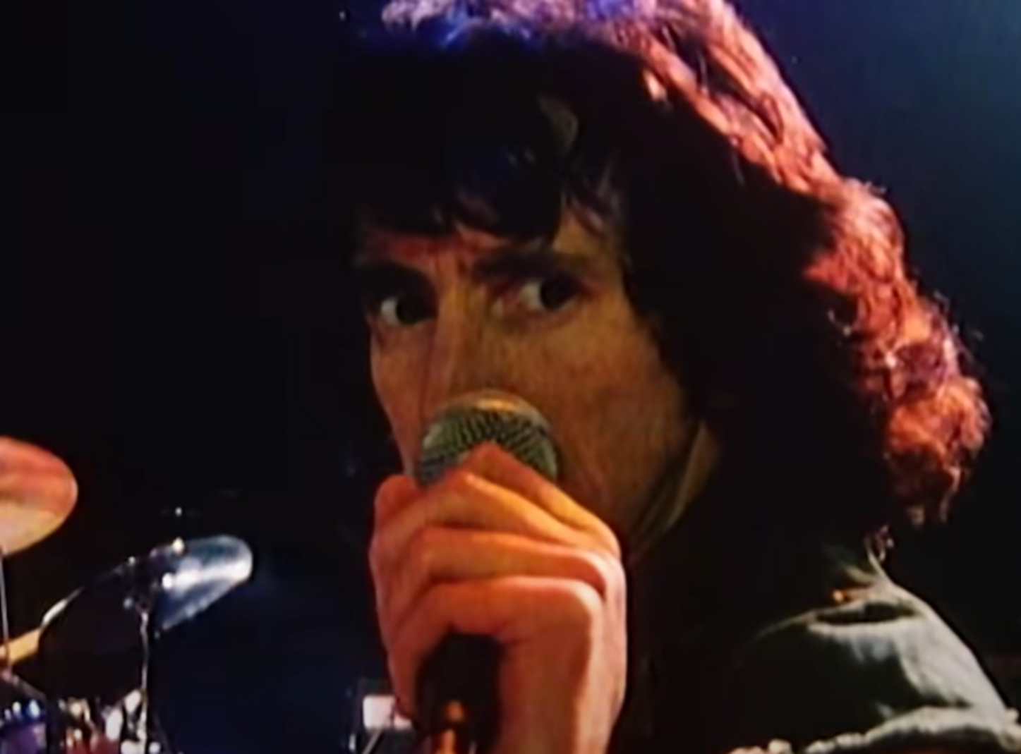 Screenshot of Bonn Scott performing on stage from - On The Brink (2022)