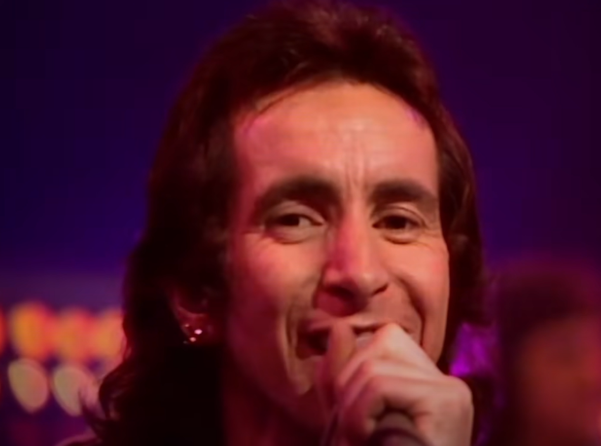 Screenshot of Bonn Scott smiling at camera from - On The Brink (2022)