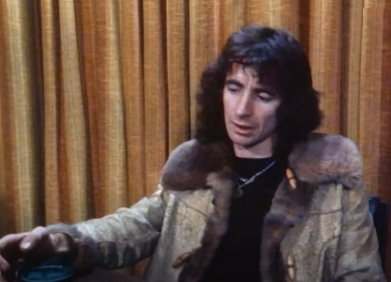 Screenshot of Bonn Scott looking at side from - On The Brink (2022)