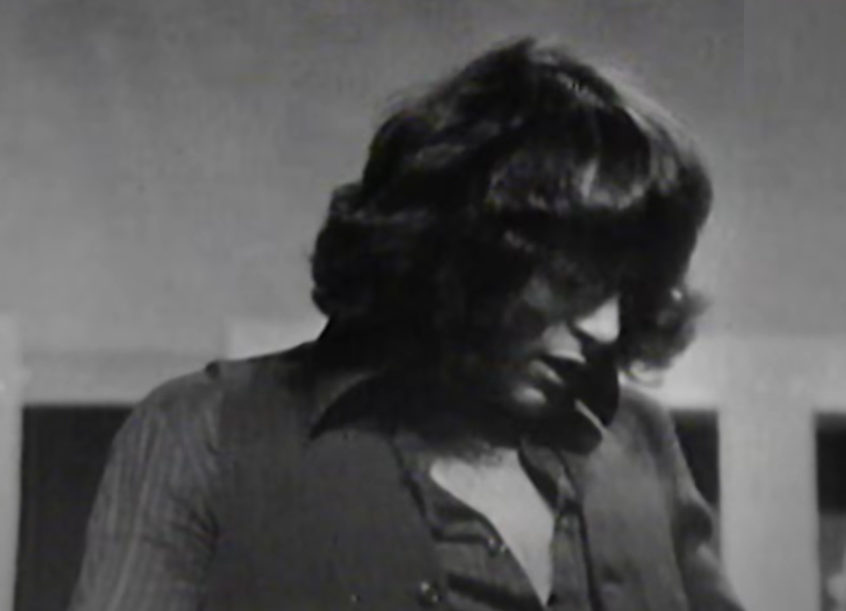 Screenshot of Bonn Scott looking down from - On The Brink (2022)