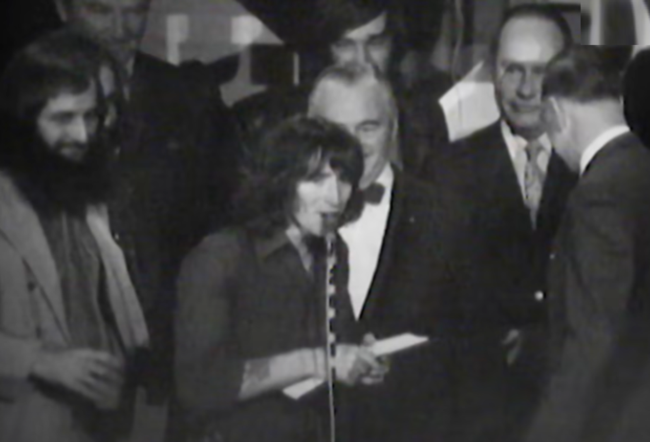 Screenshot of Bonn Scott talking on stage from - On The Brink (2022)