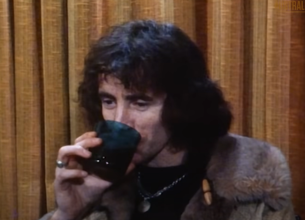 Screenshot of Bonn Scott drinking from - On The Brink (2022)