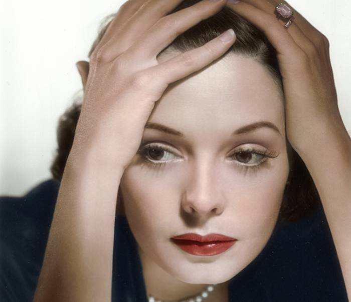 A portrait of Jane Greer holding her head