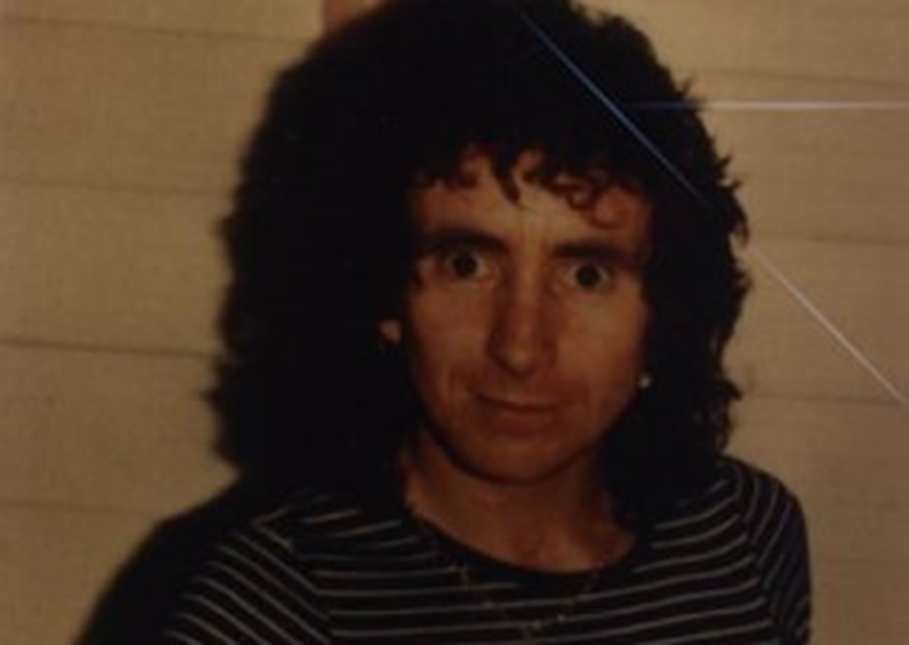 Image of Bon Scott looking at camera.